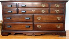 a large wooden dresser sitting on top of a hard wood floor