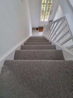 stairs leading up to a stained glass window at the top of each set of stairs