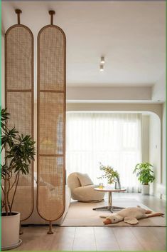 a living room filled with furniture next to a large planter in the middle of it