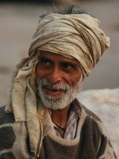 an old man with a turban on his head