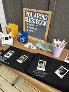 a table with polaroid guest book and other items on it