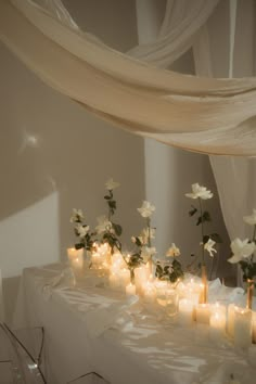 a table with candles and flowers on it