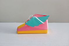 a paper shoe sitting on top of a table