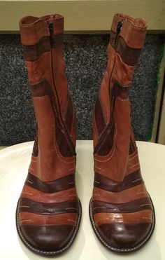 "Welcome! Vintage Leather Boots. Really original Design In good condition with some sign of use! Size 37 Made in Italy Brand: Walking On the World Measures: Heels: 2.75\" (7 cm) High boots: 9.05\" - 10.23\" (between 23 -26 cm) Thanks for stopping by!!IMPORTANT: Due to the delicate situation We're all going through, and in order to keep the safety of courier workers too, all orders will be dispatched when alert sanitary finished. You can purchased or reserve items like always. Thanks so much for Brown Leather High Ankle Wedge Boots, Brown Leather Pointed Toe Wedge Boots, Retro Brown Heeled Boots For Winter, Brown Leather Moto Boots With Pointed Toe, Brown Wide Calf Moto Boots With Snip Toe, Brown Leather Wide Calf Moto Boots, Brown Leather Moto Boots For Wide Calf, Brown Ankle-high Moto Boots With Leather Lining, Retro Brown Winter Boots