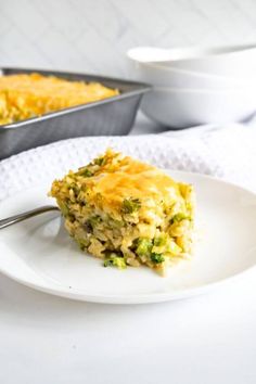 a piece of broccoli casserole on a white plate with a fork