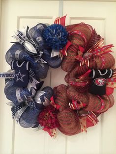 a football wreath on the front door with red, white and blue mesh balls attached to it