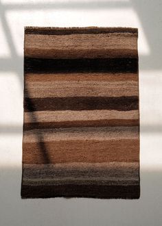 Our small accent rugs are a timeless layer for the home. Use them as a beautiful doormat or as a rug in front of your kitchen or bathroom sink. The Fallin Coconut Handwoven Rug has a palette of umber, cocoa and neutral tones. The rug is tightly woven, perfect for heavy foot traffic. Due to the vintage nature of the rug, some areas may show use. All vintage and antique rugs have been professionally cleaned. One of a kind from the 1960s. Origin: Kars, Turkey Manufacturing: Kilim Material: Wool Con Kars Turkey, Door Mat Entryway, Pine Cone Candles, Layered Rugs, Vintage Nature, Wall Sculpture Art, Handwoven Rug, Entryway Rug, Earthy Colors