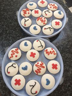 cupcakes decorated with medical symbols on blue plates