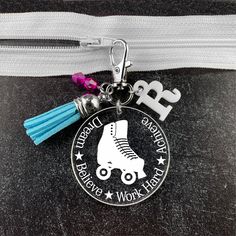 a personalized key chain with a roller skate charm