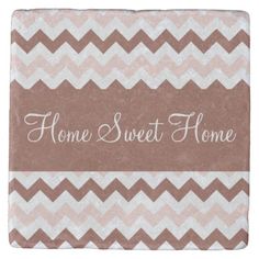 a brown and white chevroned tile with the words home sweet home on it