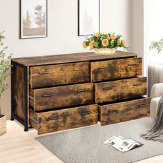 a wooden dresser sitting in a living room next to a window