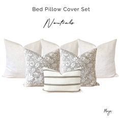 four pillows with white and gray designs on them