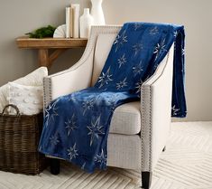 a white chair with a blue blanket on it