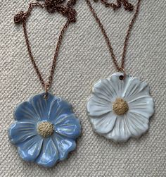 LARGE Ceramic Flower Pendant measures 2 1/4". $29  --Pendant with Your choice of cord or chain.  Soft Black Silicone cord adjusts from 16"- 18".   Copper Chain 18" or 24". Long Brown Leather cord adjusts from 22"-24". $19 --Pendant Only What exactly is Ceramic Jewelry made out of?  If you have ever seen someone working on a potters wheel "throwing a pot" then you have seen the type of clay that I work with. I start with the same big chunk of clay, Porcelain or Stoneware clay, and make each pendant individually. Each piece goes through multiple firings at very high temperatures just like potters do with the mugs and vessels that they create. Flower Pendant Necklace With Adjustable Cord, Flower-shaped Jewelry With Adjustable Cord For Gifts, Flower Shaped Jewelry With Adjustable Cord As A Gift, Ceramic Pendant Necklace, Wheel Throwing, Ceramic Necklace, Nail Jewelry, Earning Money, Clay Necklace