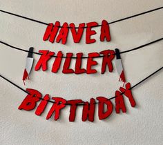 the words have been cut out to say'have a killer birthday'on string