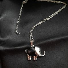 Perfect for animal lovers seeking both style and protection, our Elegant Elephant Pendant with chain is a stunning piece that combines elegance with the powerful properties of Black Obsidian. Crafted with attention to detail, this pendant showcases a beautifully designed elephant with intricate detailing, making it a true work of art. Imbued with the natural energy of Black Obsidian, this protection necklace is believed to shield its wearer from negative energies and promote a sense of grounding and stability. The deep, lustrous black of the stone adds an element of mystique to the pendant, making it a captivating accessory for any outfit. The pendant comes complete with a chain, allowing for easy and comfortable wear. The chain is made from high-quality materials and is durable enough to Black Spiritual Nickel-free Necklace, Nickel-free Black Spiritual Necklaces, Nickel-free Black Spiritual Necklace, Black Nickel-free Spiritual Necklaces, Black Nickel-free Spiritual Necklace, Silver Animal Design Jewelry For Gifts, Silver Jewelry With Animal Design For Gift, Black Metal Amulet Necklace, Nickel Free Black Pendant Necklace