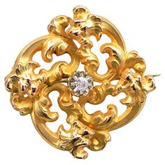 Brooch in 18 karats yellow gold, eagle's head hallmark. This elegant antique brooch is composed of an openwork vegetal decoration in relief. The work of yellow gold is sometimes dull, sometimes brilliant to accentuate the relief of the antique jewel. An antique brilliant cut diamond is set with claws in the center. The clasp is pin with safety hook. Total diamond weight: about 0.05 carat. Total height: 2.9 cm, width: 2.9 cm, widest thickness: about 8.2 mm. Total weight of the jewel: approximatel Bijoux Art Nouveau, French Art Nouveau, Gold Baroque, Vintage Jewelry Art, Antique Brooches, Art Nouveau Jewelry, Diamond Brooch, Gold Work, Jewel Box