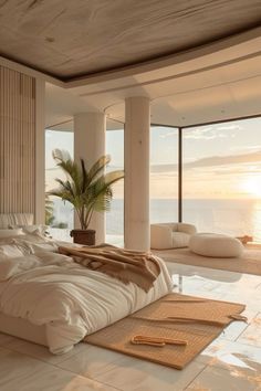 a large bed sitting in the middle of a bedroom next to a window with an ocean view