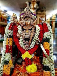 the statue is decorated with flowers and other decorations