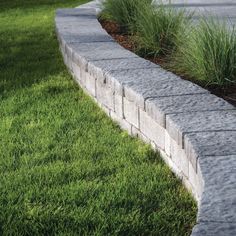 a brick wall and grass in the foreground