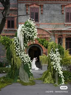 a bride and groom are standing in front of an old building with flowers on it