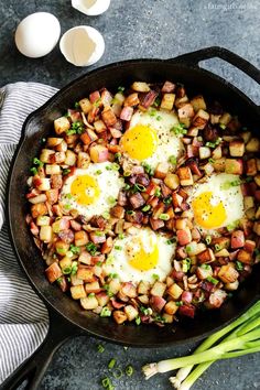 eggs and potatoes in a skillet with green onions