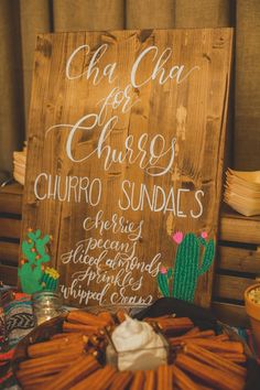 a sign that says churro sundaes next to other food items on a table