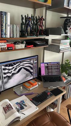 a laptop computer sitting on top of a desk next to a desktop computer monitor and keyboard