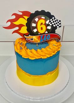 a blue and yellow cake with a number six on top