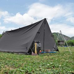 a tent is pitched up in the grass