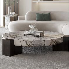 a marble coffee table with books on it