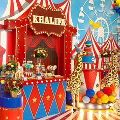 a circus themed birthday party with giraffes and balloons