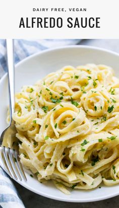 a white plate topped with pasta and parsley