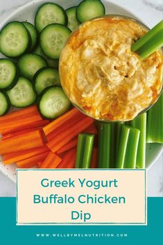 greek yogurt buffalo chicken dip on a plate with cucumbers and celery