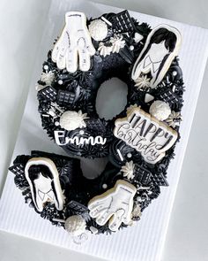 decorated cookies in the shape of a wreath on top of a white box with writing happy halloween