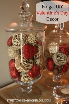 two glass jars filled with valentine's day decorations