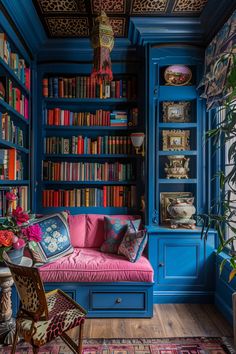 a living room with blue bookshelves and pink couch in the corner, surrounded by colorful rugs