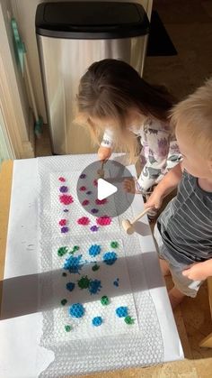 two children are playing with legos on the table