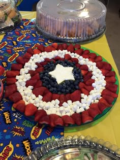 there is a cake on the table with red, white and blue decorations around it