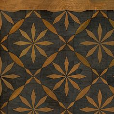 a wooden table with an intricate design on it's surface and wood grain in the middle