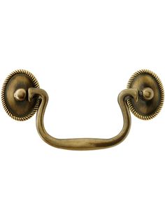 an antique brass door handle on a white background