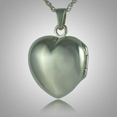 The Heart Locket Picture Keepsake Pendant is sterling silver and crafted by an artistic skilled jeweler one at a time. The quality is excellent and the craftsmanship is outstanding. This Keepsake Pendant holds a small amount of remains, a piece of hair or something that is small enough to memorialize your loved one and bring them close to your heart. Locket Picture, One At A Time, Religious Symbols, Rosary Beads, Cremation Jewelry, Heart Locket, Drops Design, Locket, Pearl Earrings