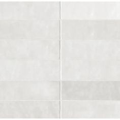 a white tile wall with horizontal lines on it