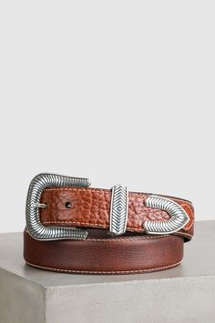 Artistic styling and rugged good looks make this bison leather belt a premium choice for everyday wear. The Pickett is all about contrast, from the smooth, matte leather with topstitch border to the naturally grained leather overlay, to the bold, silver-plated buckle, keeper, and tip. Buffalo leather lining ensures a comfort fit all day long. Silver Leather Belt With Buckle Closure, Leather Belt Buckles For Rodeo, Classic Leather Belt Buckles For Rodeo, Silver Leather Concho Belt Buckles, Brown Leather Rodeo Belt, Rustic Leather Belt Buckle With Removable Belt, Brown Leather Belt For Rodeo, Leather Concho Belt Buckles For Rodeo, Western Brown Belt Buckles With Silver Buckle