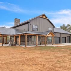 a large house sitting on top of a dirt field