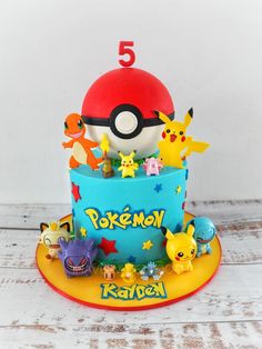 a pokemon themed birthday cake with pikachu and other characters on the top tier