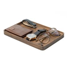 a wooden tray with glasses, watch and wallet