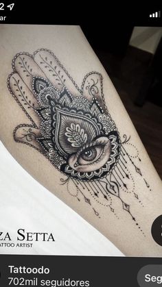 a black and white tattoo on the leg of a woman with an owl in her hand