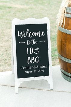 a welcome sign sitting next to a barrel