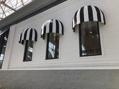 three black and white awnings on the side of a building